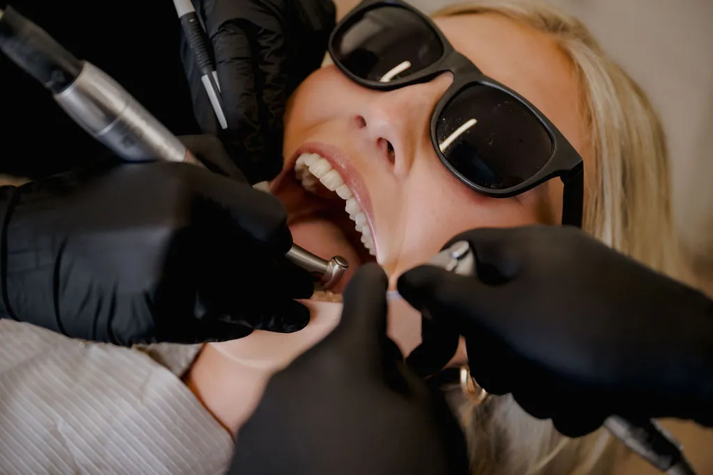 Dentist performing root canal treatment to save a damaged tooth in Oklahoma City